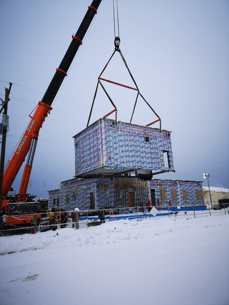 Crane lifting a modular unit in Nunavut