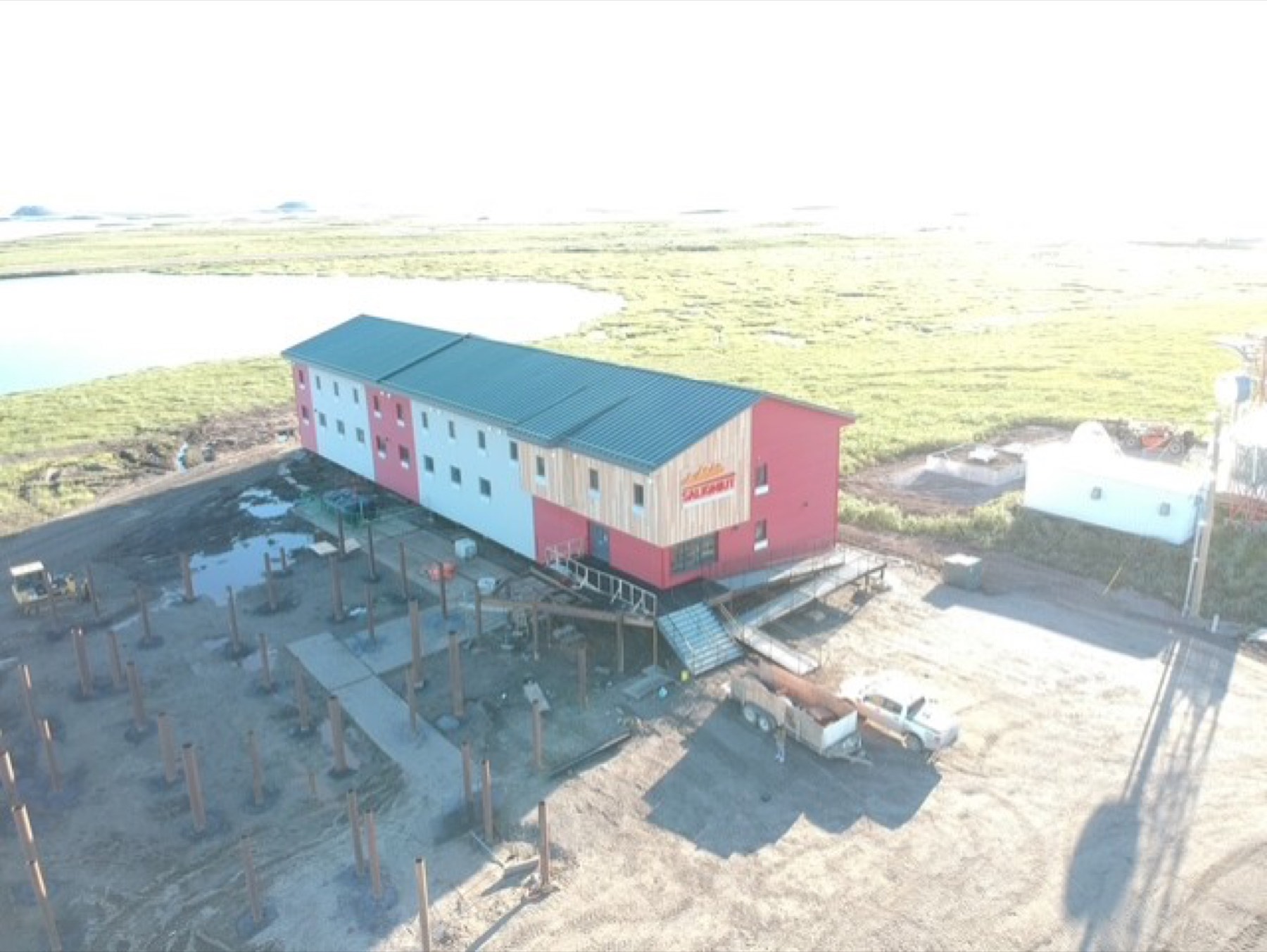 Modular workforce lodge being installed on a steel pile foundation