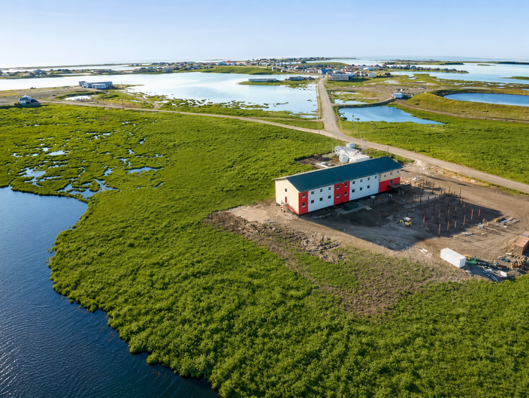 Aerial site-review view of a modular building project and its surroundings
