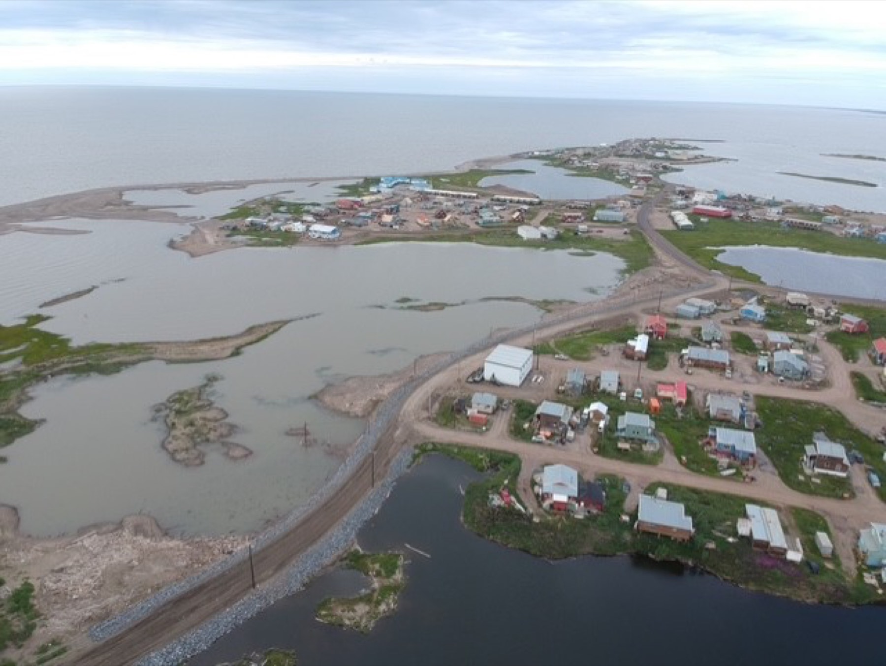 Aerial view of a remote Arctic community served by modular construction and seasonal logistics