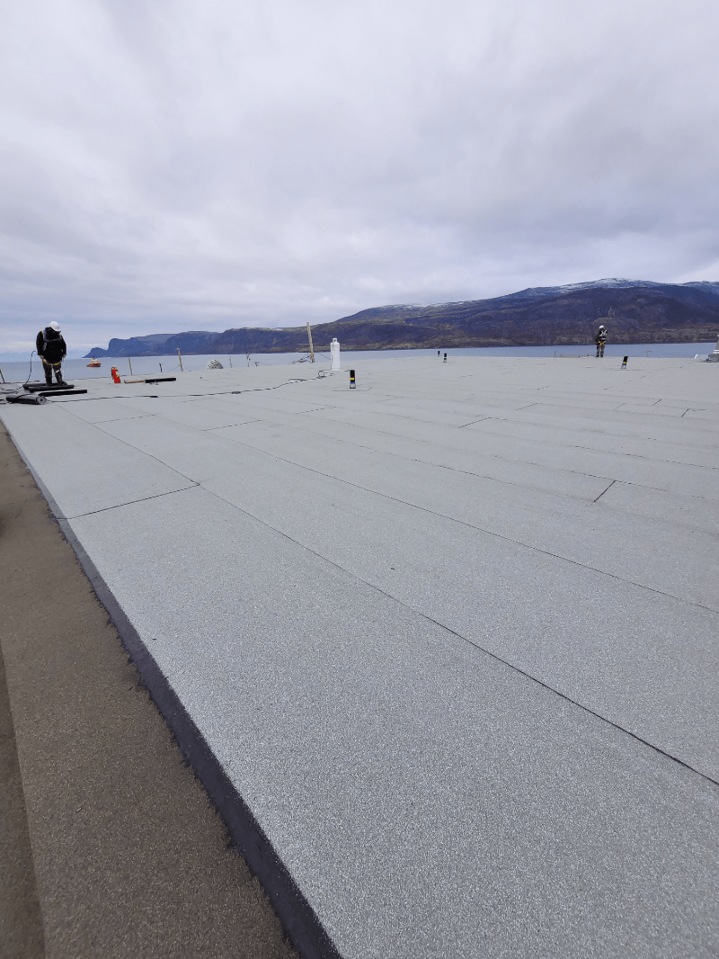 Roofing installation on a modular building near the coast